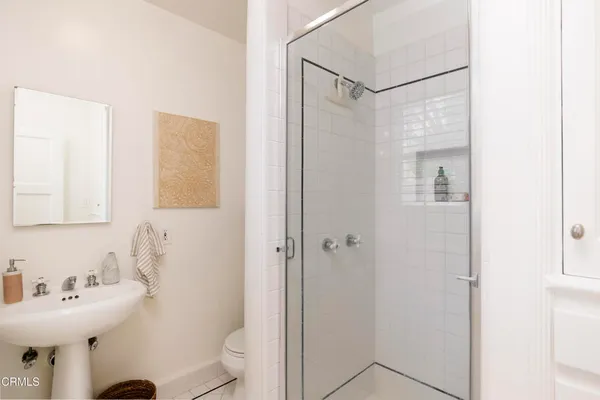 a bathroom with a sink mirror and a toilet