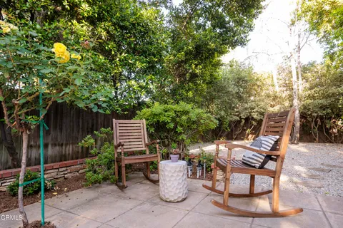 a view of a chair and tables in the backyard