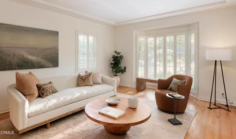 a living room with furniture and a potted plant
