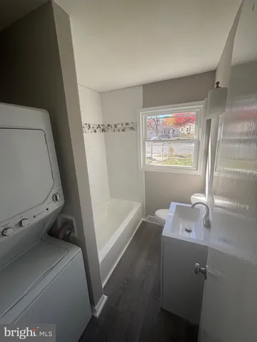 a bathroom with a tub sink and mirror