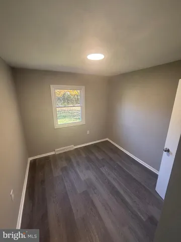 a view of a yard with large trees