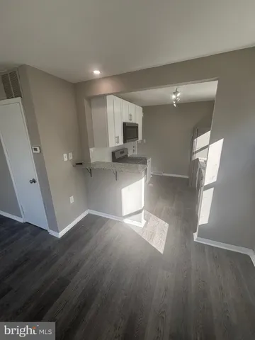 a view of a kitchen with a sink and dishwasher wooden floor