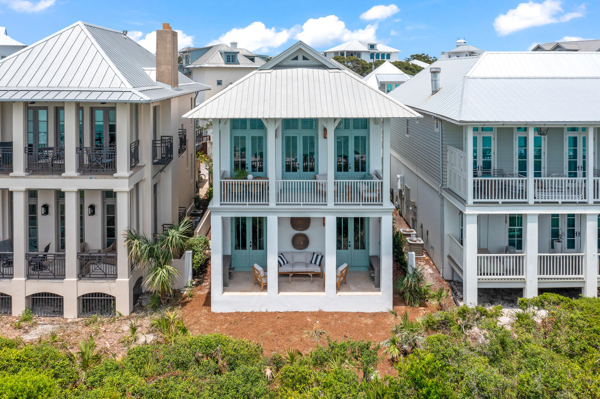 84 Windward Lane Inlet Beach, FL 32461 - Photo 2 of 67 a view of a white house with a large windows and a yard with plants and large trees