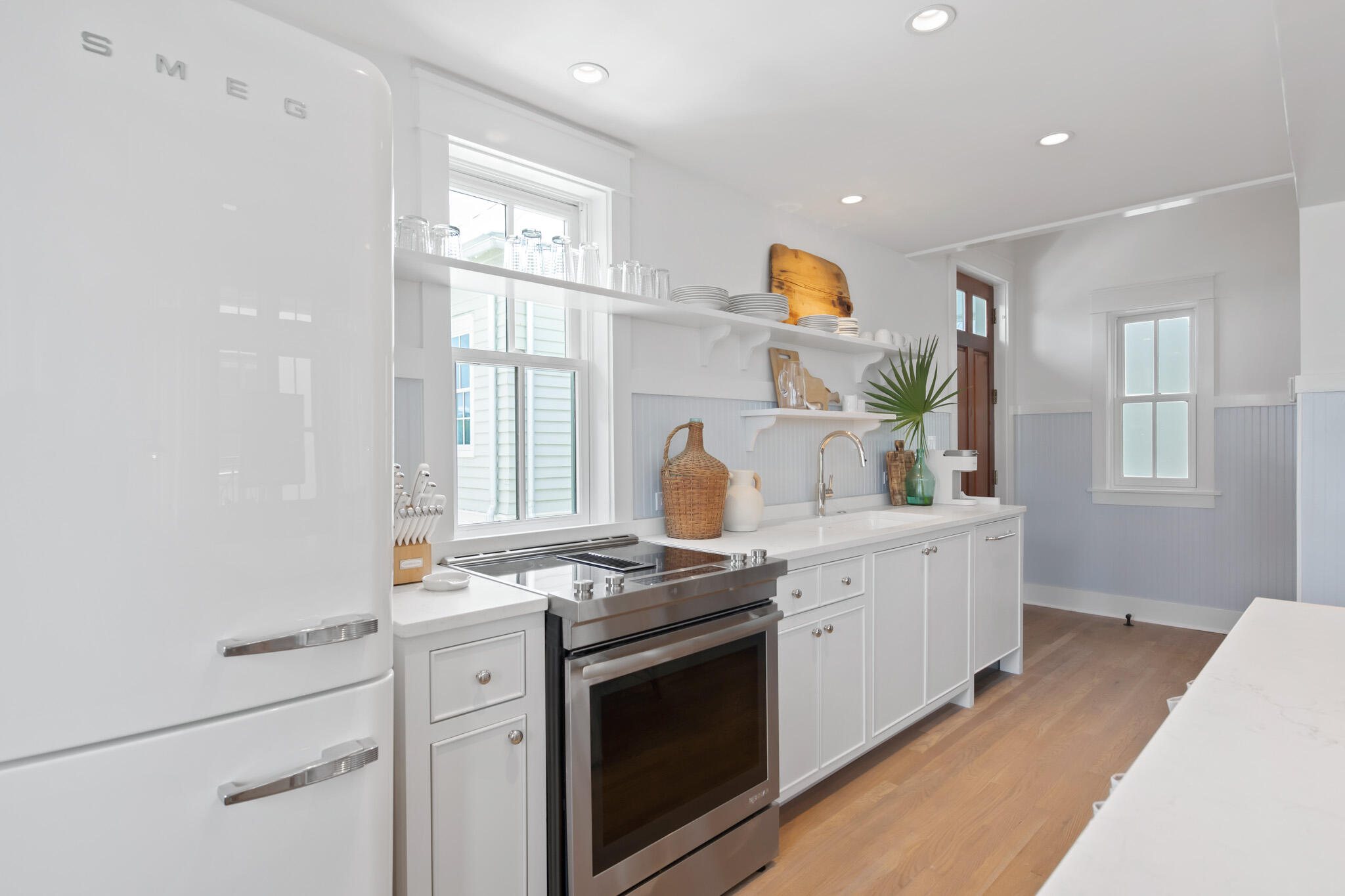 84 Windward Lane Inlet Beach, FL 32461 - Photo 60 of 67 a kitchen with stainless steel appliances white cabinets and wooden floors