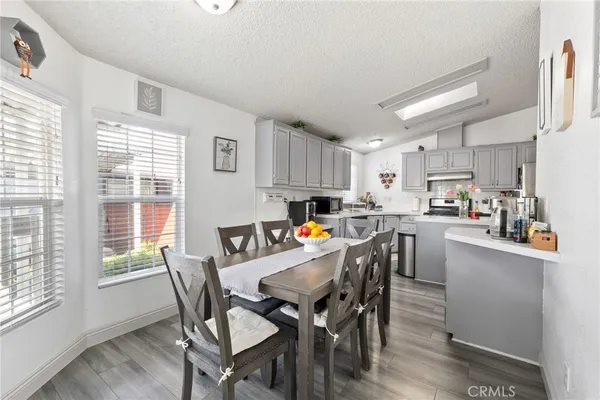 a kitchen with stainless steel appliances a refrigerator sink and white cabinets