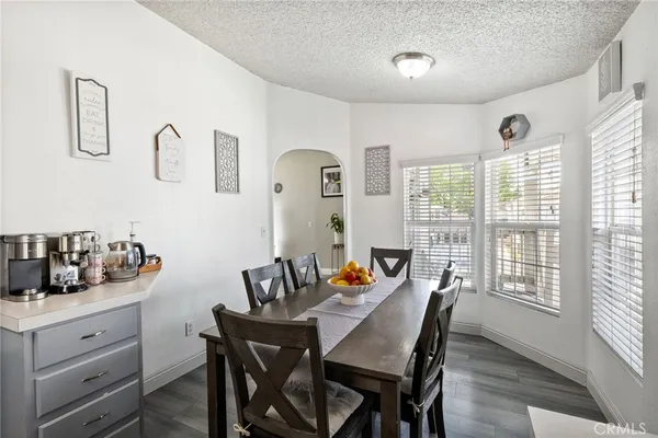 a kitchen with stainless steel appliances kitchen island granite countertop a stove a kitchen island a dining table and chairs