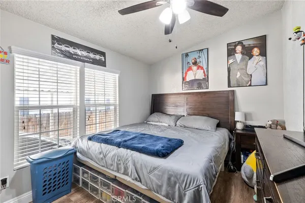 a bedroom with a bed and a lamp with the wooden floor