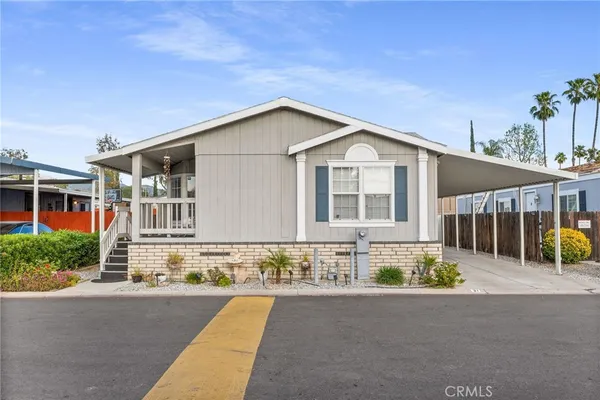 a front view of a house with a road and yard