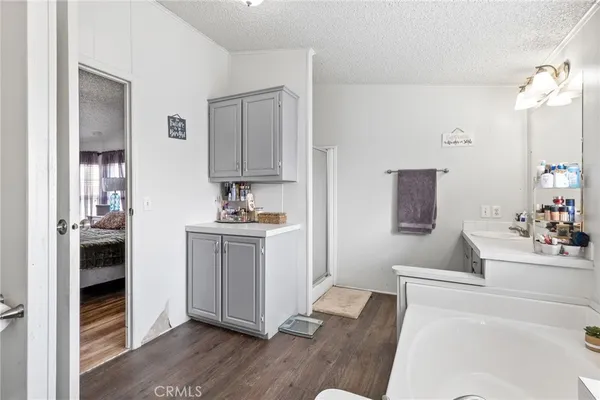 an aerial view of a city with lots of residential buildings ocean and mountain view in back