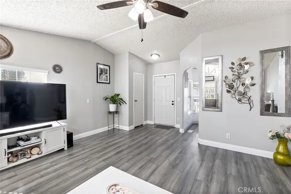 a living room with furniture and wooden floor