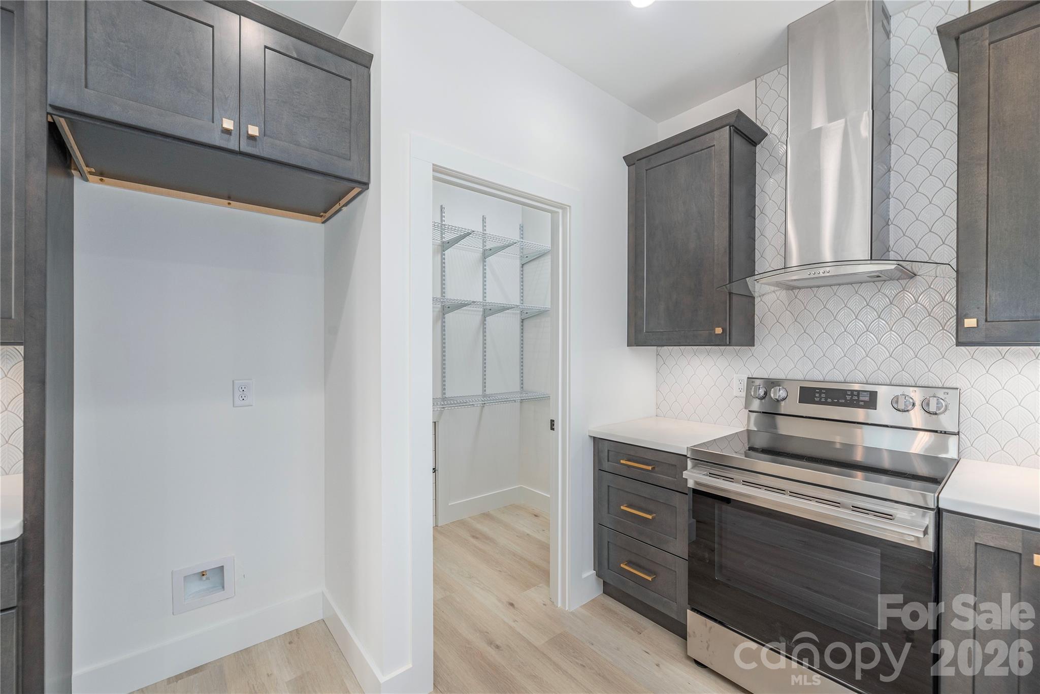32 Oak Hill Road Candler, NC 28715 - Photo 12 of 29 a kitchen with stainless steel appliances a stove a microwave and cabinets