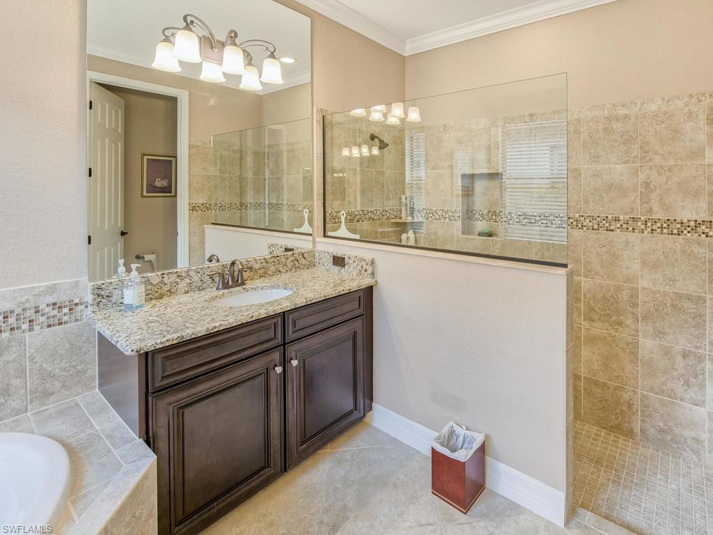 9491 Piacere Way Naples, FL 34113 - Photo 15 of 34 a spacious bathroom with a sink double vanity and a mirror