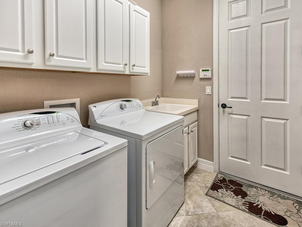 9491 Piacere Way Naples, FL 34113 - Photo 20 of 34 a utility room with dryer and washer