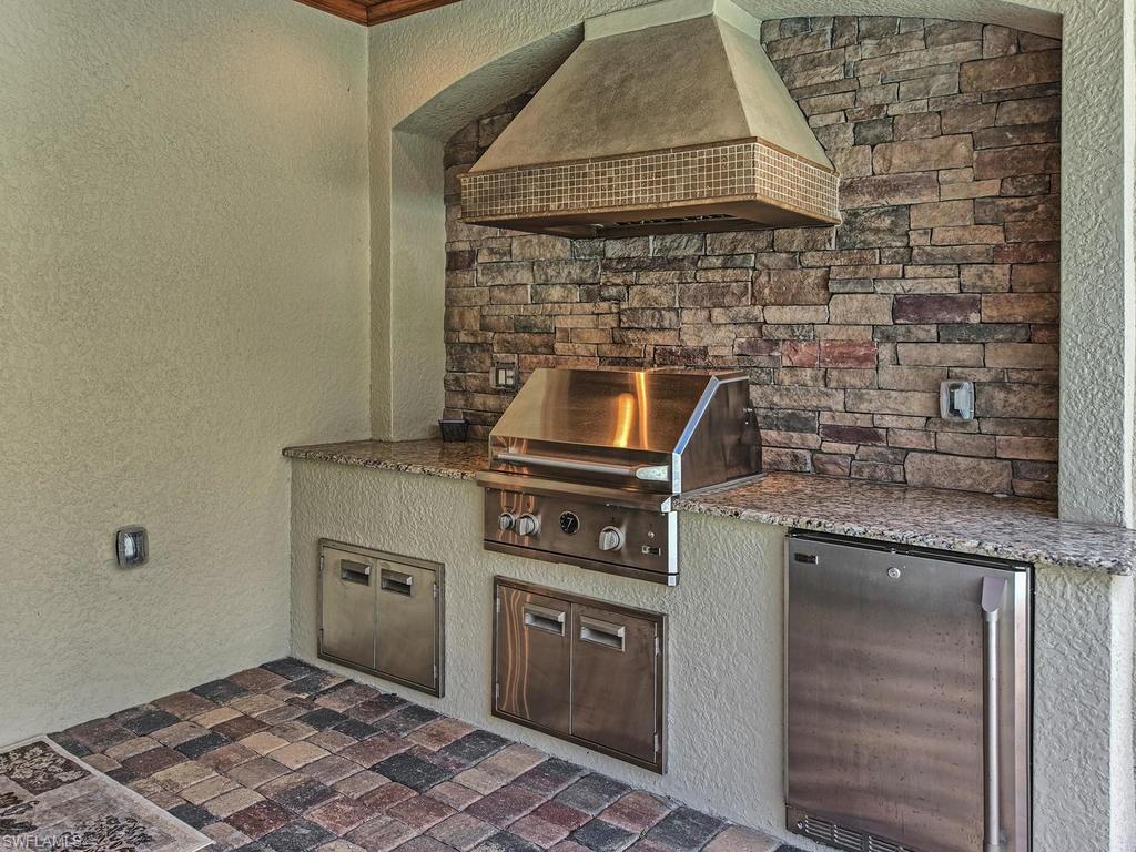 9491 Piacere Way Naples, FL 34113 - Photo 22 of 34 a kitchen with a stove and a microwave