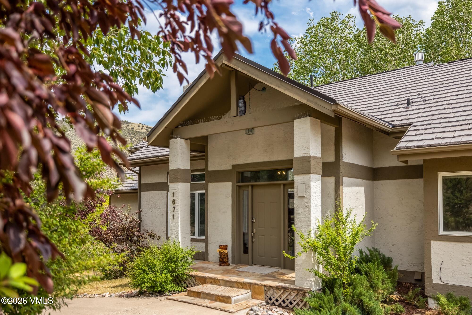 1671 Winslow Road Edwards, CO 81632 - Photo 4 of 48 a front view of a house with garden