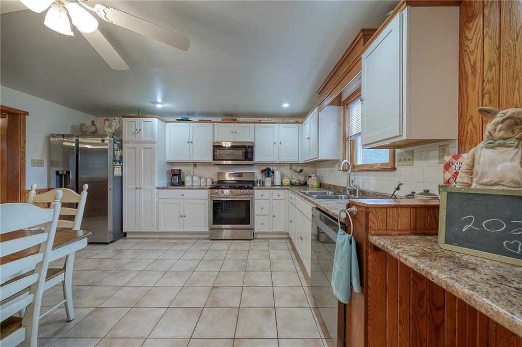 148-149 Soaring Eagle Sarver, PA 16055 - Photo 7 of 20 a kitchen with a sink a counter top space stainless steel appliances and cabinets