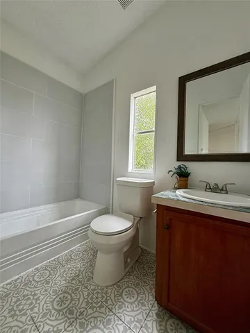 a bathroom with a sink toilet a mirror and vanity