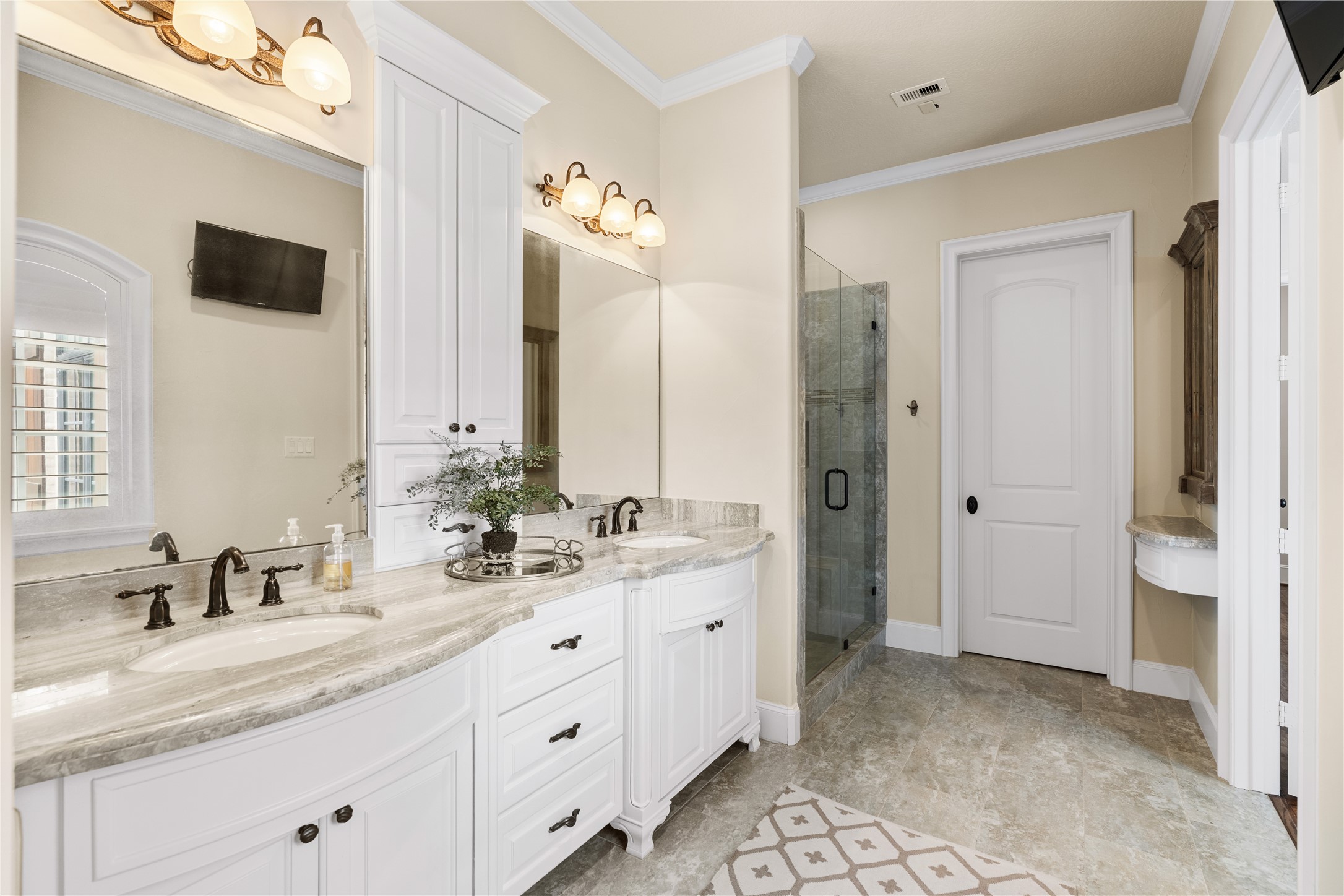 12349 Longmire Trace Conroe, TX 77304 - Photo 24 of 48 Spa-like bathroom with double vanity, marble-look counters, glass shower, and generous built-in storage.