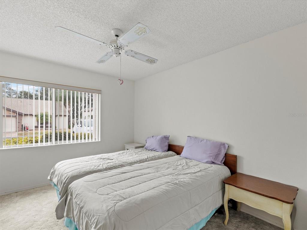 7415 Heather Walk Drive Weeki Wachee, FL 34613 - Photo 11 of 35 a bedroom with a bed and a window