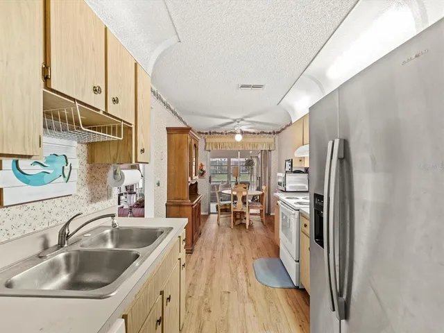 a kitchen with counter top space a sink and refrigerator