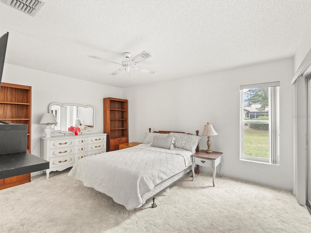 7415 Heather Walk Drive Weeki Wachee, FL 34613 - Photo 17 of 35 a bedroom with a bed a window and dresser
