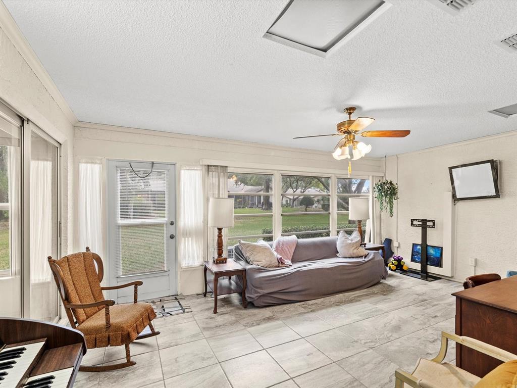 7415 Heather Walk Drive Weeki Wachee, FL 34613 - Photo 22 of 35 a living room with furniture and a large window