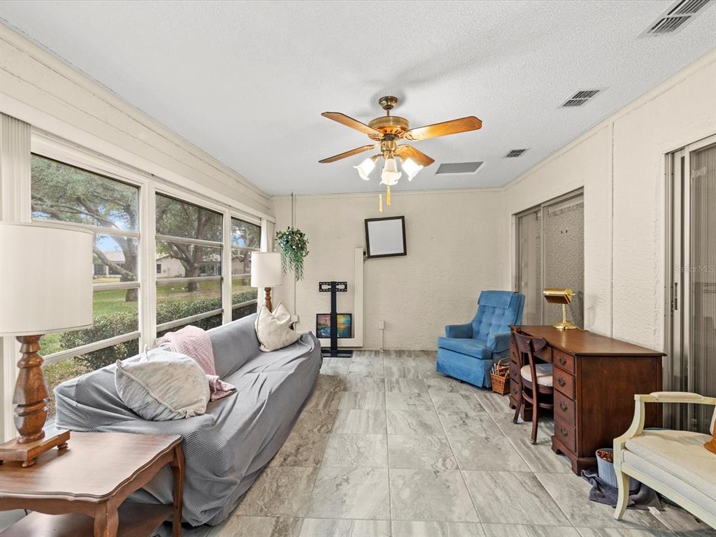 7415 Heather Walk Drive Weeki Wachee, FL 34613 - Photo 23 of 35 a living room with furniture and a large window