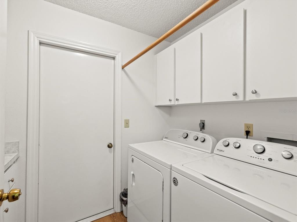 7415 Heather Walk Drive Weeki Wachee, FL 34613 - Photo 4 of 35 a utility room with dryer and washer
