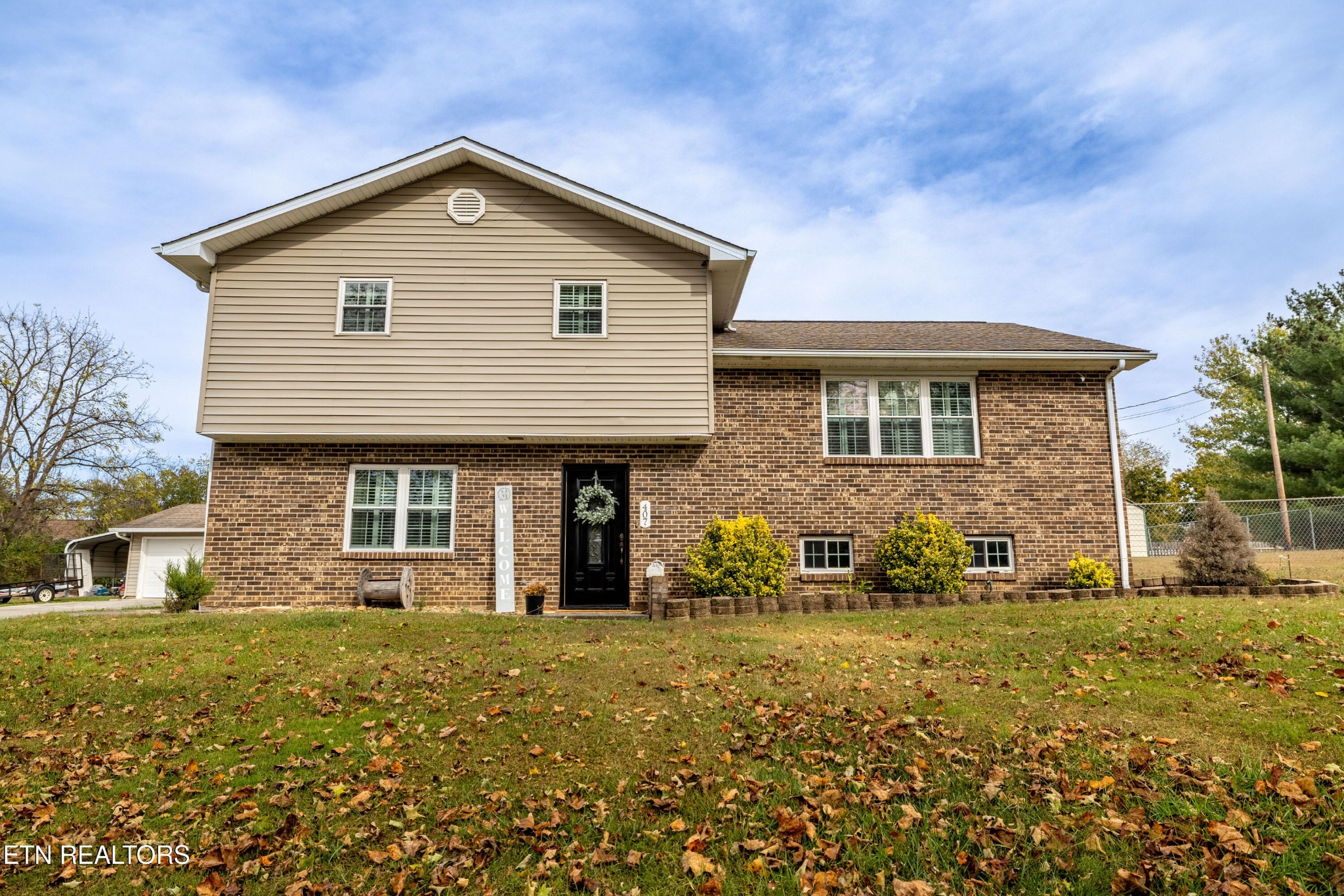 a front view of a house with a yard