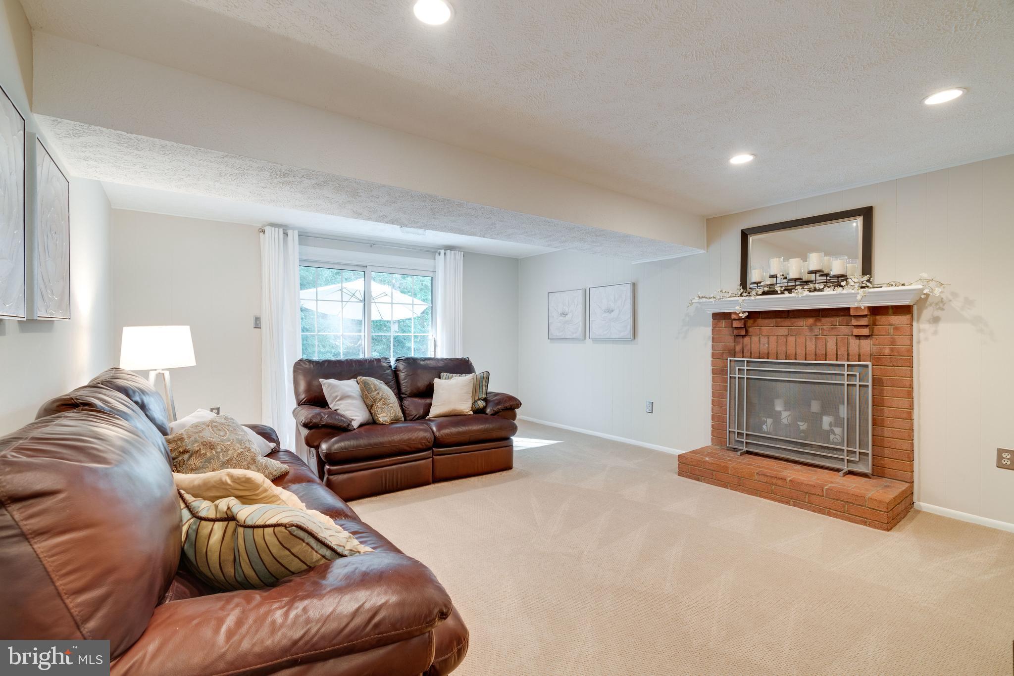 8315 Cushing Court Springfield, VA 22153 - Photo 39 of 59 basement family room w/ fireplace and walk-out