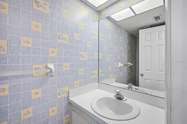 a bathroom with a sink a mirror and a shower