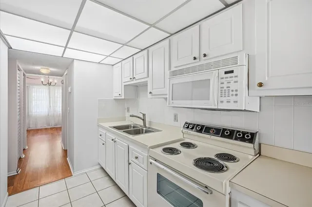 a kitchen with a sink a stove and cabinets