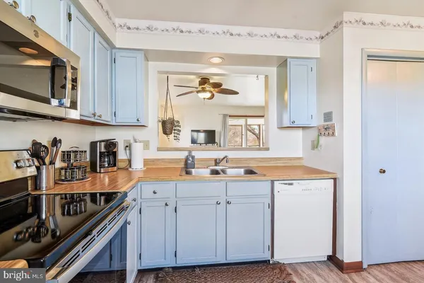 a kitchen with stainless steel appliances granite countertop a sink and cabinets