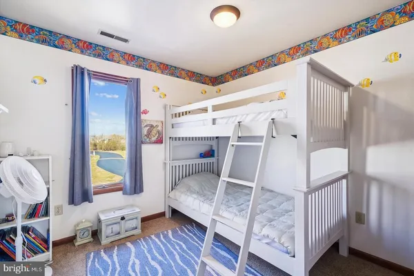 a living room with furniture and a baby crib