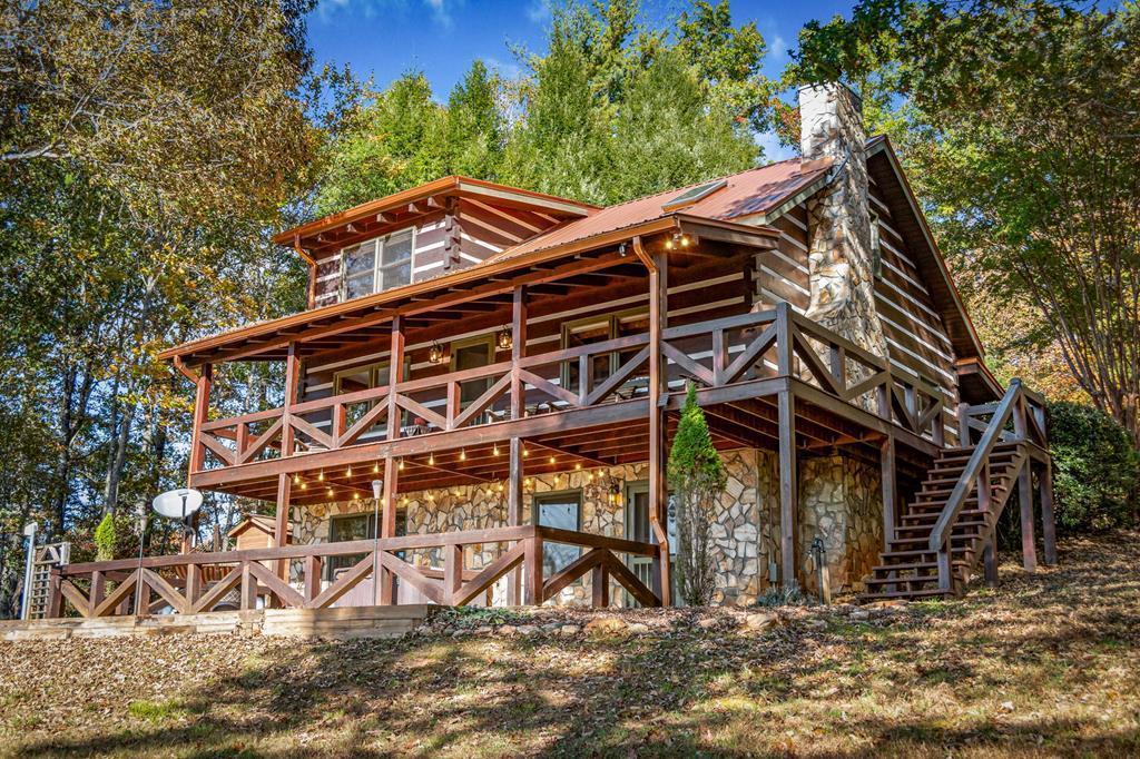 212 Dogpatch Lane Blue Ridge, GA 30513 - Photo 1 of 70 a front view of a house with parking area
