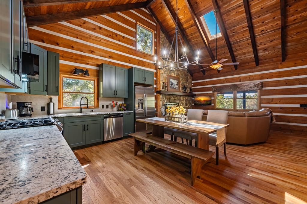 212 Dogpatch Lane Blue Ridge, GA 30513 - Photo 16 of 70 a kitchen with a stove a sink and a refrigerator