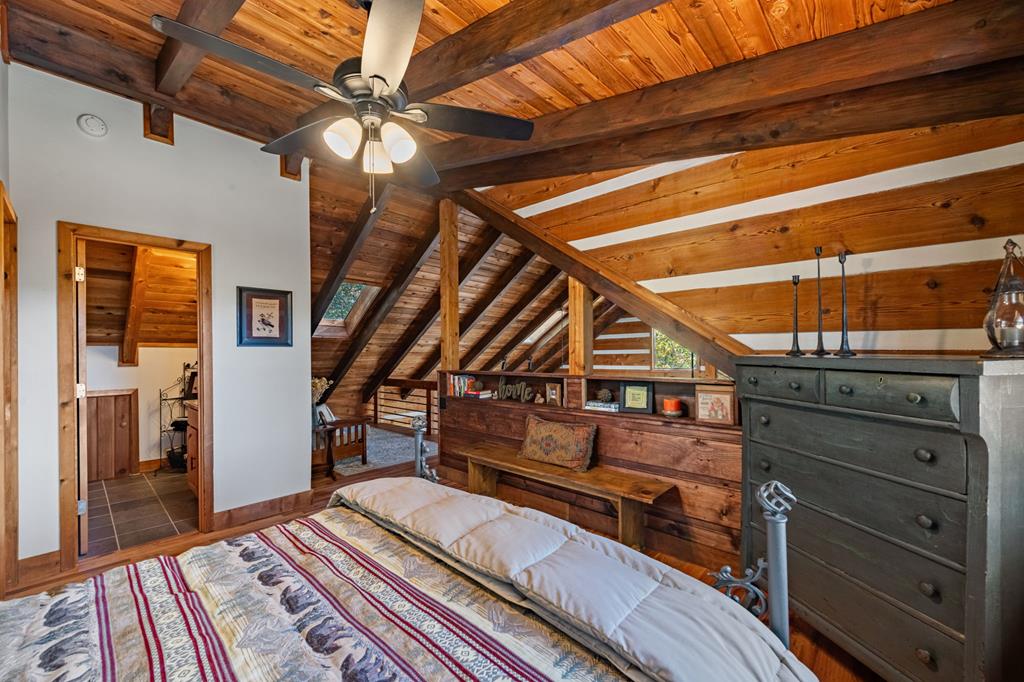 212 Dogpatch Lane Blue Ridge, GA 30513 - Photo 26 of 70 a bed room with a bed and a chandelier