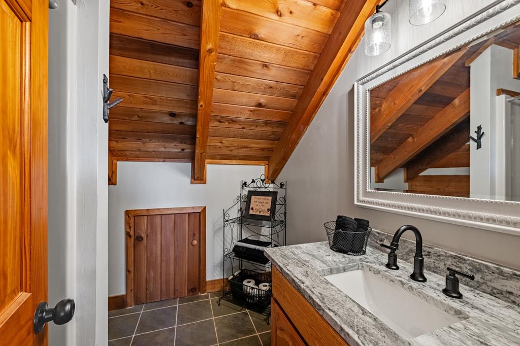212 Dogpatch Lane Blue Ridge, GA 30513 - Photo 28 of 70 a bathroom with a sink and a mirror