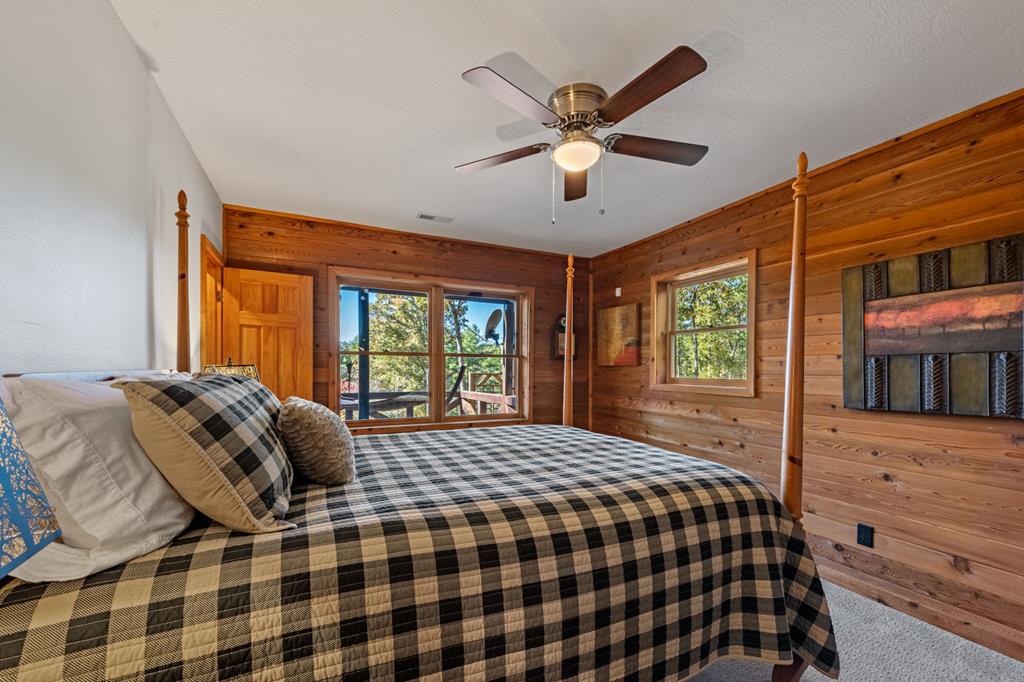 212 Dogpatch Lane Blue Ridge, GA 30513 - Photo 32 of 70 a bedroom with a large bed and a window