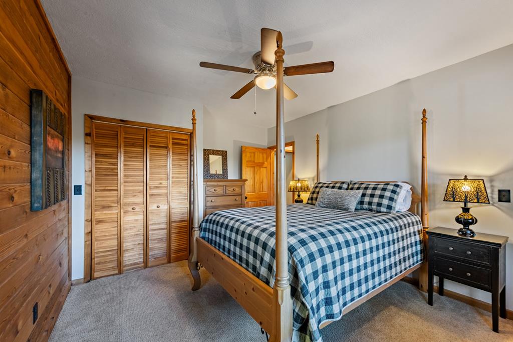 212 Dogpatch Lane Blue Ridge, GA 30513 - Photo 33 of 70 a bedroom with a bed and a chandelier