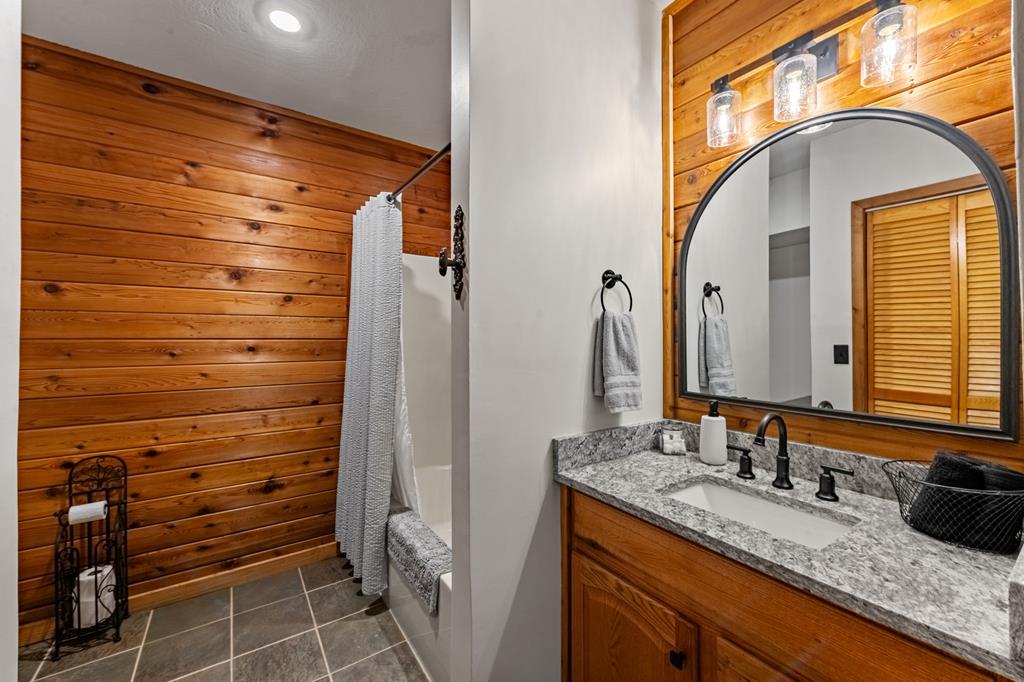 212 Dogpatch Lane Blue Ridge, GA 30513 - Photo 34 of 70 a bathroom with a granite countertop sink and a mirror