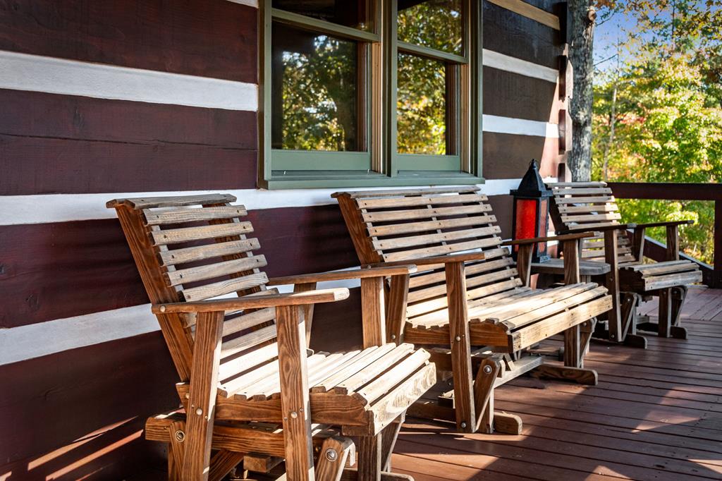 212 Dogpatch Lane Blue Ridge, GA 30513 - Photo 37 of 70 a view of a patio with table and chairs with wooden floor and fence