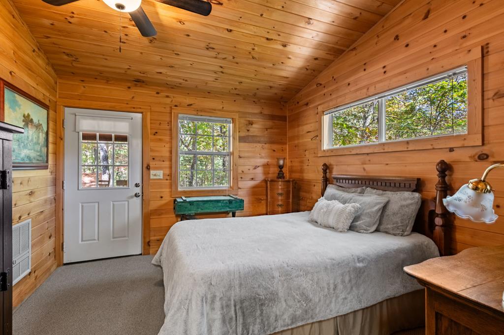 212 Dogpatch Lane Blue Ridge, GA 30513 - Photo 50 of 70 a bedroom with a bed and large windows