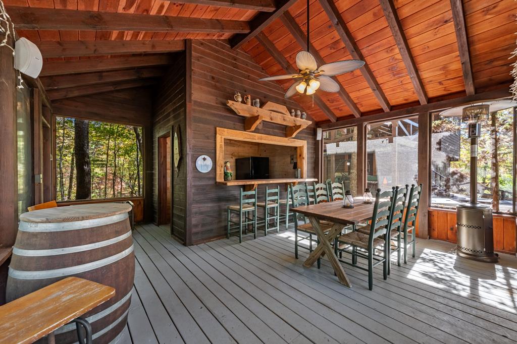 212 Dogpatch Lane Blue Ridge, GA 30513 - Photo 58 of 70 a view of a patio with table and chairs with wooden floor and fence