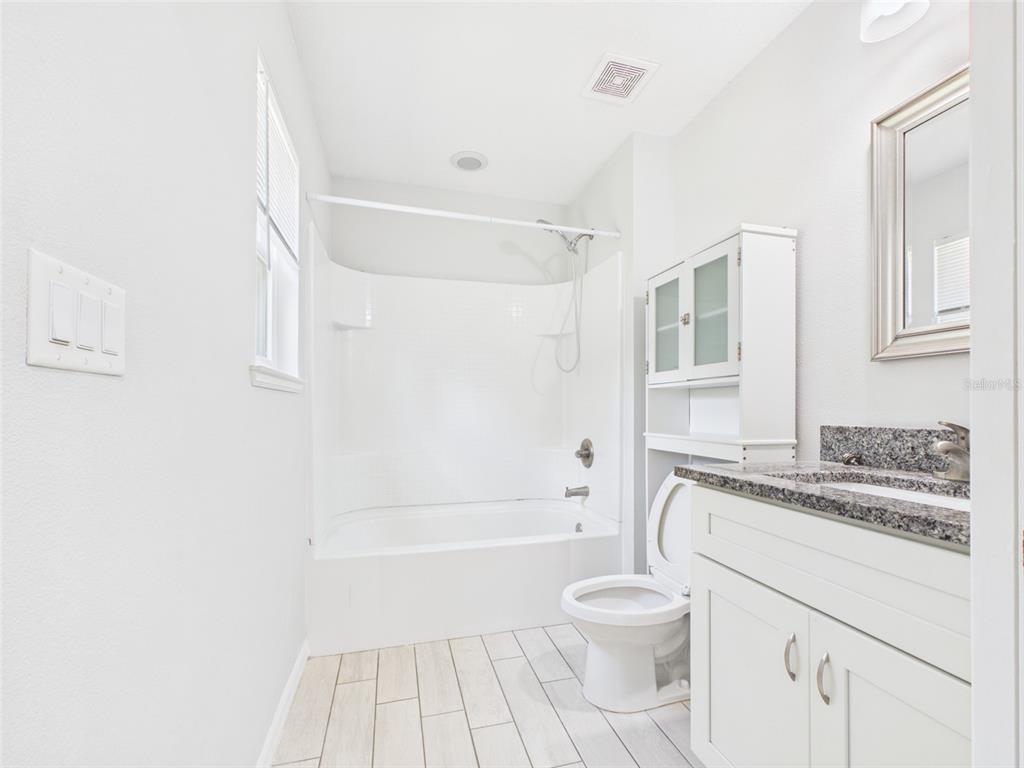 4309 Southwest 143rd Ln Road Ocala, FL 34473 - Photo 16 of 21 a bathroom with a sink a toilet and shower