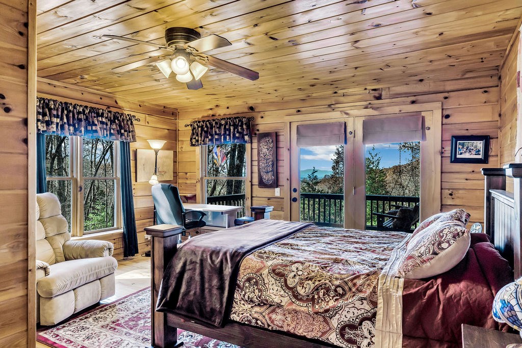 116 Channing Ridge Road Morganton, GA 30560 - Photo 24 of 62 a bed sitting in a bedroom next to a large window