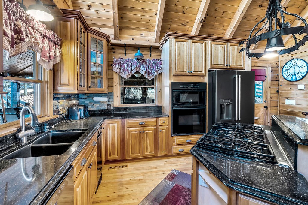116 Channing Ridge Road Morganton, GA 30560 - Photo 6 of 62 a kitchen with stainless steel appliances granite countertop a stove and a sink
