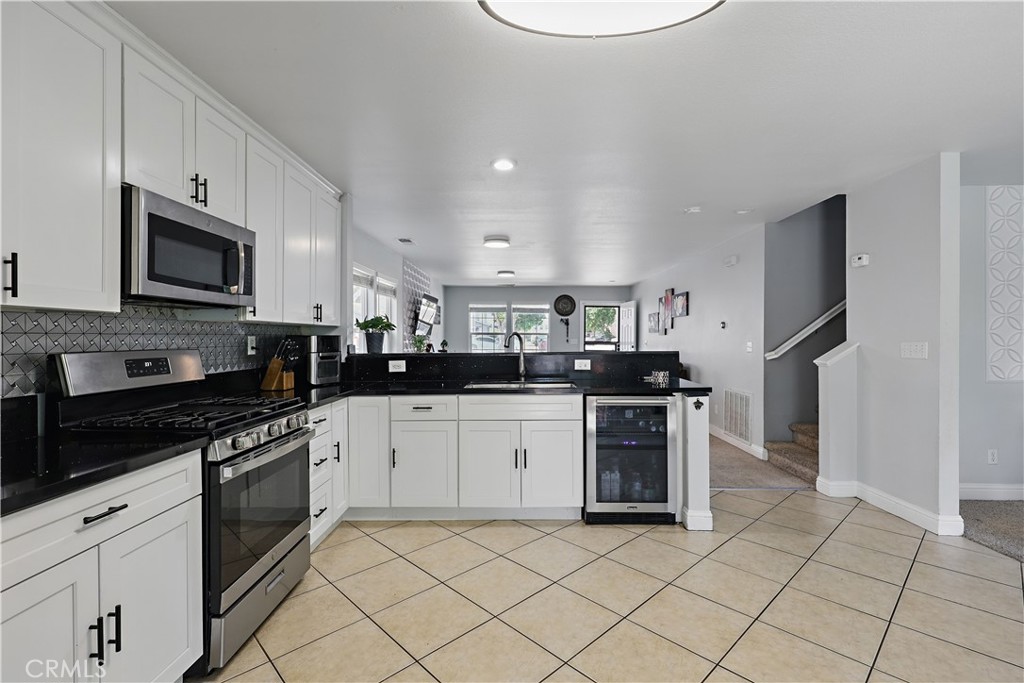1235 Sunrise Drive Merced, CA 95348 - Photo 12 of 44 a kitchen with stainless steel appliances granite countertop a stove a sink and a microwave