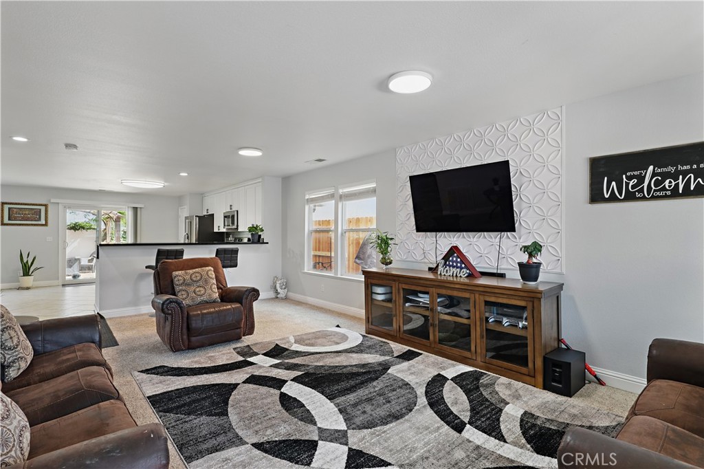1235 Sunrise Drive Merced, CA 95348 - Photo 15 of 44 a living room with furniture and a flat screen tv