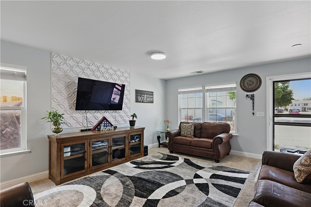 1235 Sunrise Drive Merced, CA 95348 - Photo 17 of 44 a living room with furniture and a flat screen tv